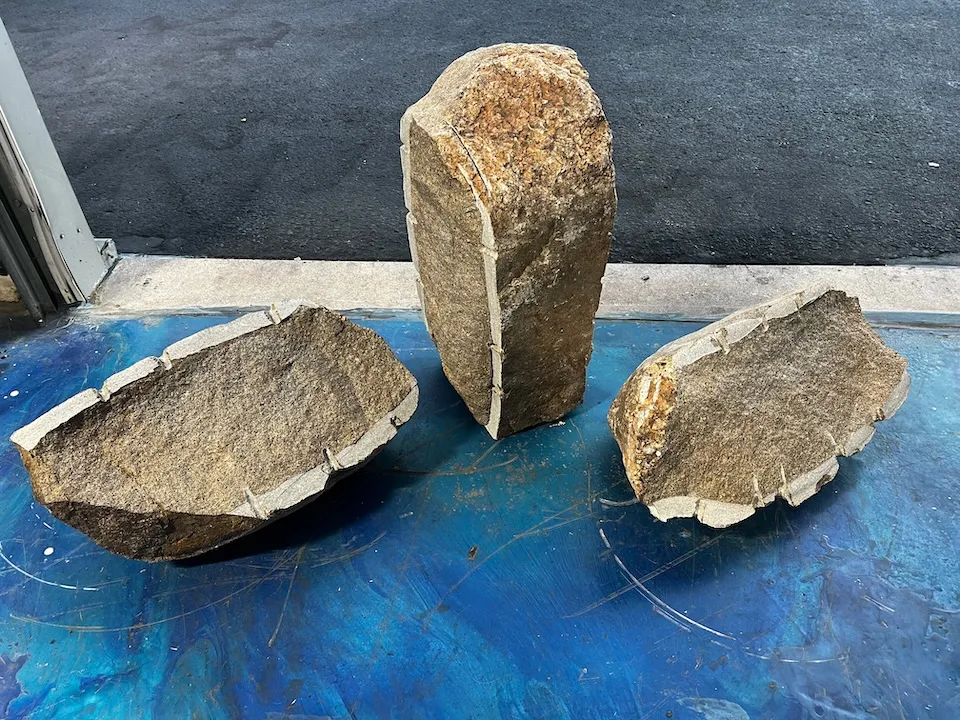 Three pieces split of glacially carved granodiorite